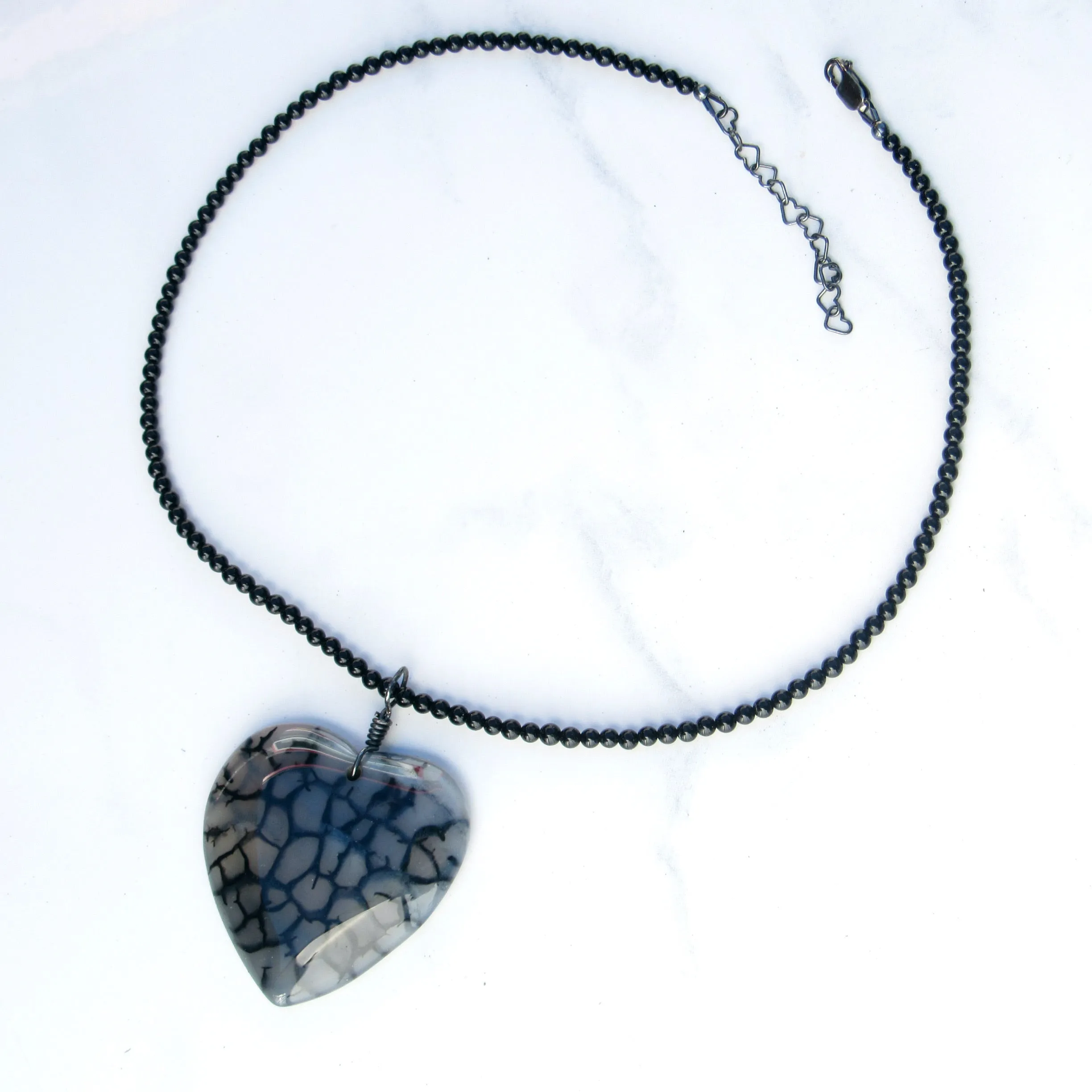 Hand Wrapped Dragon’s Vein Agate Heart on Onyx necklace with Oxidized Sterling Clasp