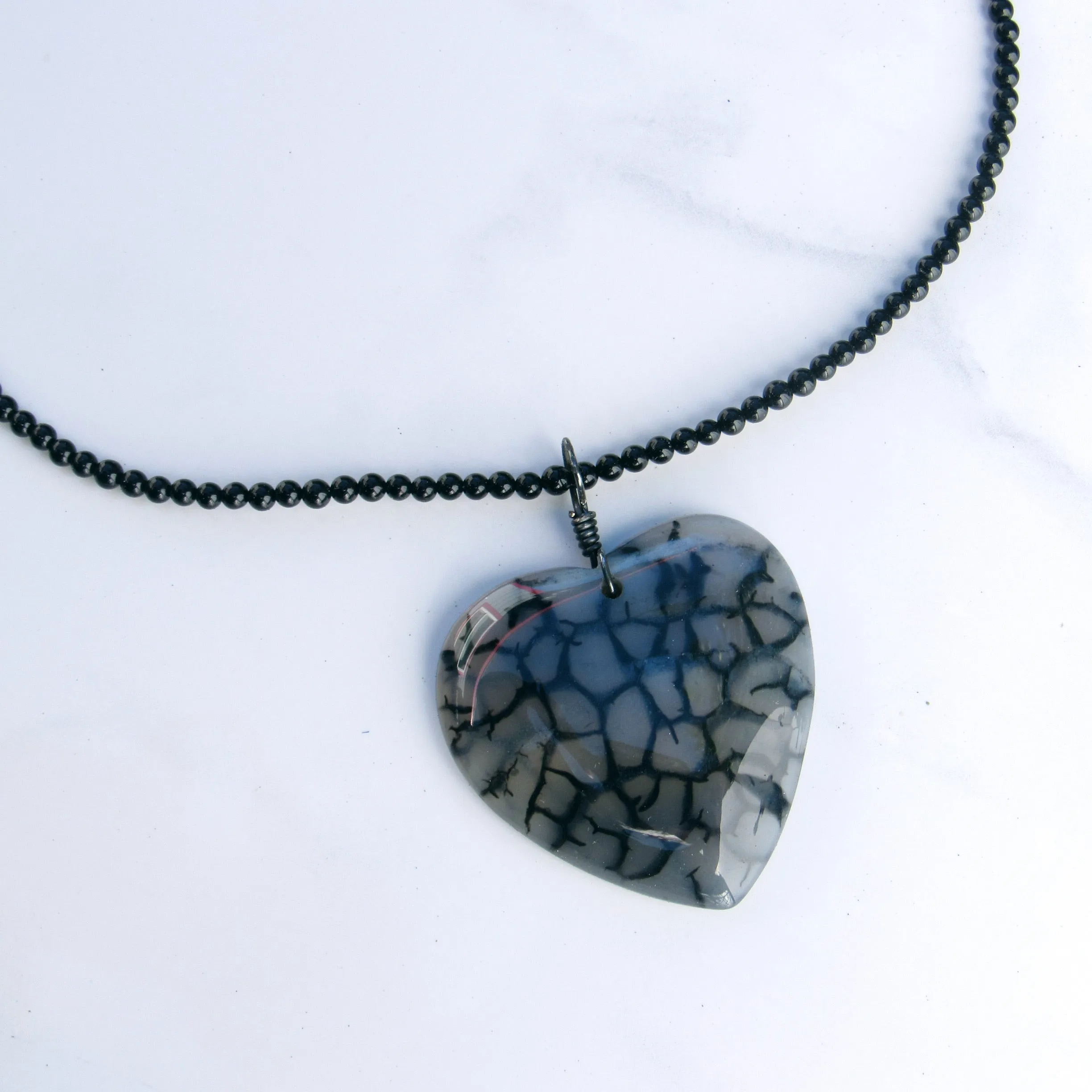 Hand Wrapped Dragon’s Vein Agate Heart on Onyx necklace with Oxidized Sterling Clasp