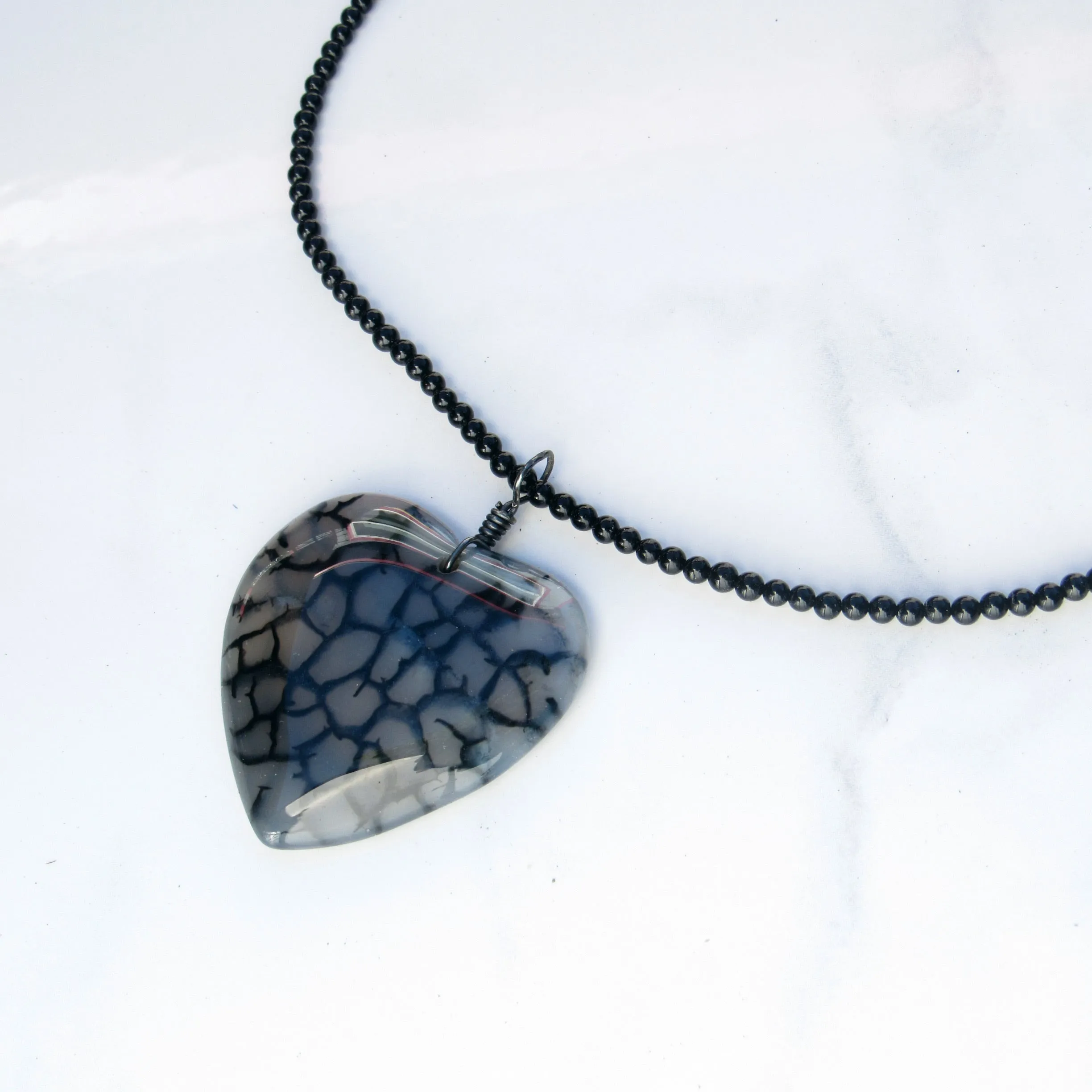 Hand Wrapped Dragon’s Vein Agate Heart on Onyx necklace with Oxidized Sterling Clasp